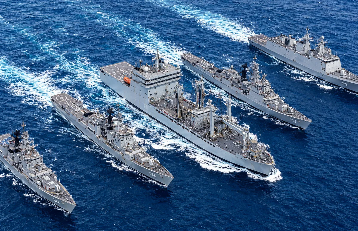 Naval surface fleet and replenishment ship underway in formation at sea