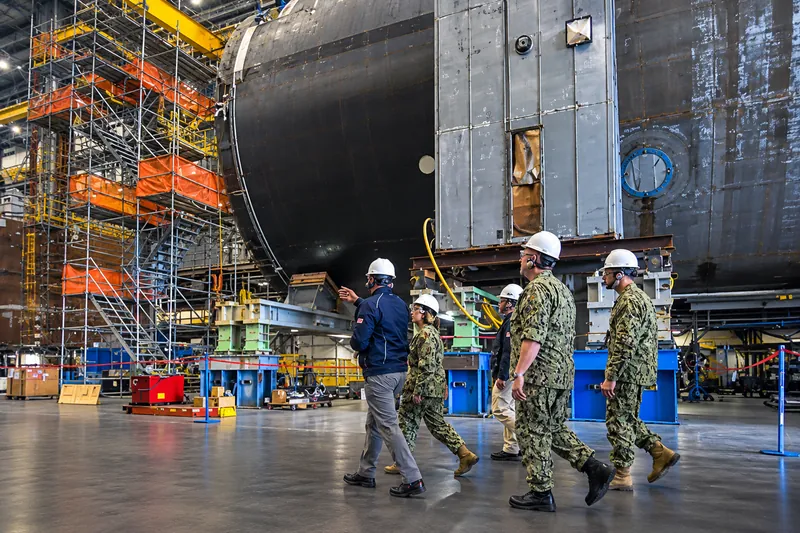 Naval Sustainment defense domain: Navy personnel in a submarine construction facility